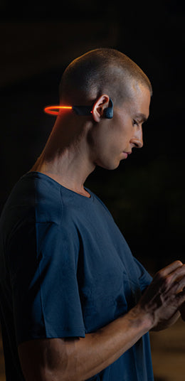Man wearing HAKII Light LED MP3 Player Bluetooth Earbuds